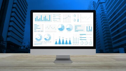 Statistics graphs, charts and diagrams data on modern computer monitor screen on wooden table over office city tower and skyscraper, Business financial intro motion background - Powered by Adobe