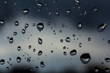 A small raindrop rests on the glass after rain.