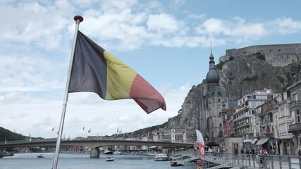 Belgian Flag Flapping in the Wind at the Rear of a Boat in Dinant, Belgium - Powered by Adobe