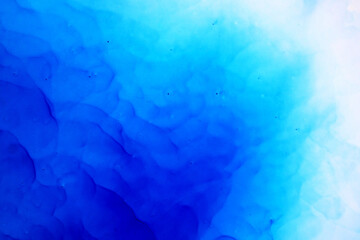 Blue Background. Blue ink texture with abstract washes and paint stains on the white paper background. Hand painted background. Blue ink background for design