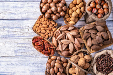 Various nuts on old wooden background.