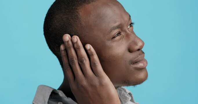 Profile of black man touching his painful ear
