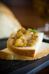 cooked eggplant caviar with spices on a wooden table