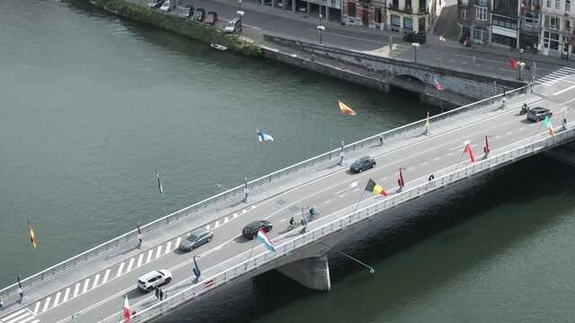 Dinant's Bridge in River Meuse. Cars Passing and National Flags Flapping in the Wind