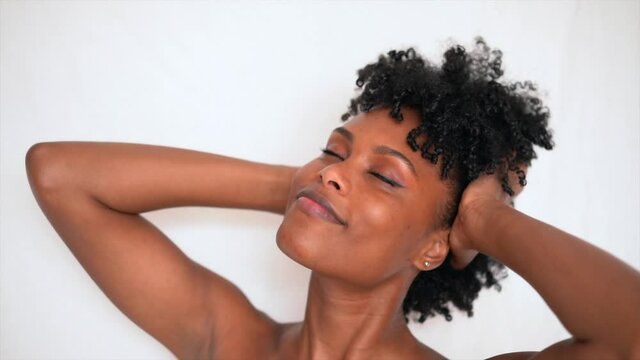 Young black woman playing with her afro hair