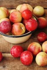 Nectarines and plums on a wooden table macro