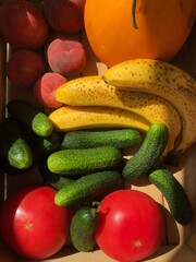 Seasonal fruits and vegetables in a wooden box