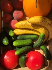 Seasonal fruits and vegetables in a wooden box