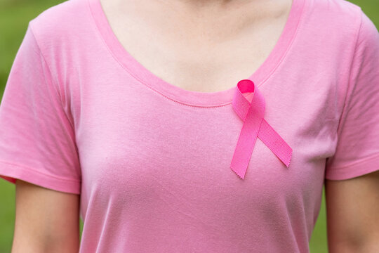 October Breast Cancer Awareness month, adult Woman in pink T- shirt and Pink Ribbon for supporting people living and illness. International Women, Mother and World cancer day concept