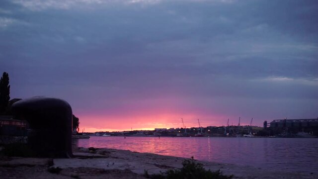 Beautiful Sunset from Sicily, Italy. Footage. Great seascape with purple and red sky and industrial port on background.