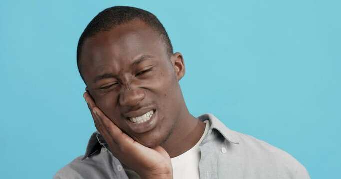African american guy suffering from strong tooth pain