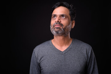Fototapeta premium Portrait of mature bearded Indian man with curly hair