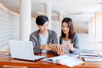 High school or college students  group catching up workbook and learning tutoring on desk and reading, doing homework, lesson practice preparing exam.