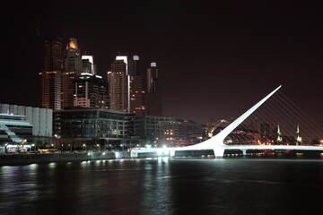 Fototapeta na wymiar View of The Waterfront with Women's Bridge at night in Buenos Aires, Argentina