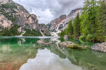 Dolomites in the reflection of the crystal waters of the famous Lake Braies