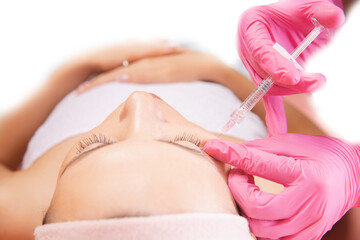 Obraz na płótnie Canvas Woman getting injection procedure anti wrinkle corners of eyes forehead face skin. Beauty salon care