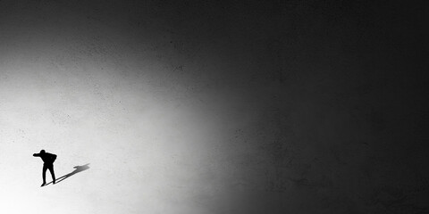 Silhouette of man walking in the night toward the light, view from above. Way of life, going...