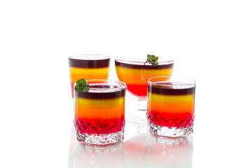 Fototapeta na wymiar Sweet multi-colored fruit puff jelly in a glass cup