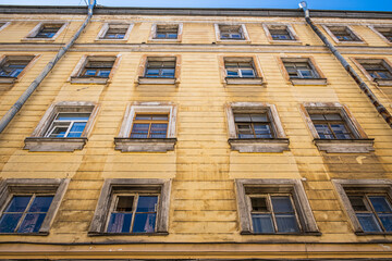 Old windows in an historic yellow house.