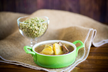 hot pea soup with meat and vegetables in a plate