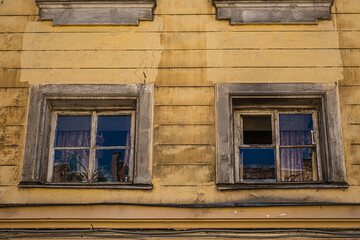 Old windows in an historic yellow house.