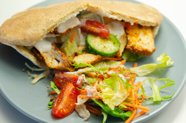Mediterranean style pitta prepared with spicy chicken, cucumber, tomato, salad and mayo sauce