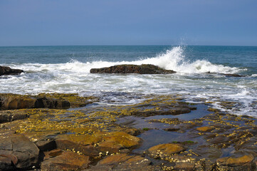 Sea breeze breaking on the rocks
