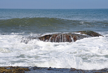 Sea breeze breaking on the rocks