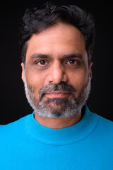 Fototapeta premium Portrait of mature bearded Indian man with curly hair