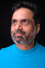 Fototapeta premium Portrait of mature bearded Indian man with curly hair