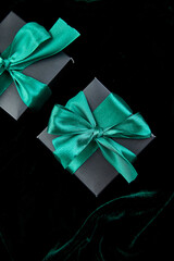 Luxury black gift boxes with green ribbon