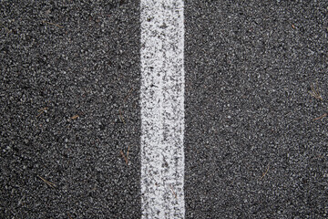 White line painted on asphalt, texture.