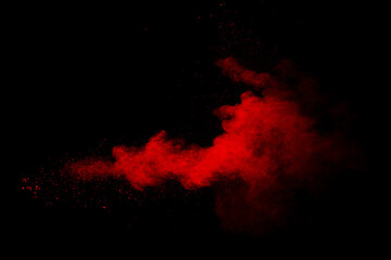 Fototapeta na wymiar Abstract red powder on black background. Red color clouds.