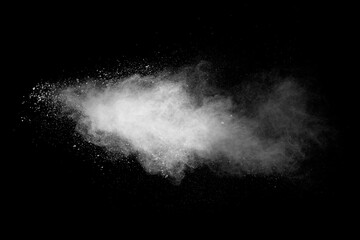 White powder explosion isolated on black background. White dust particles splash.Color Holi...