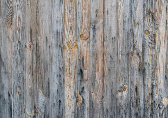 An old and rotten wooden fence. Old boards.