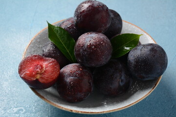 Juicy plums in a plate. Fresh Blue plums. 