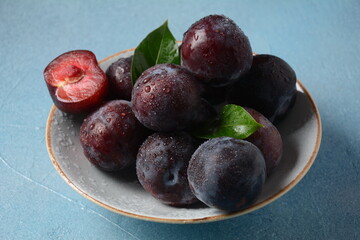 Juicy plums in a plate. Fresh Blue plums. 