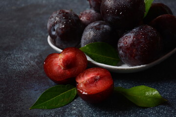 Juicy plums in a plate. Fresh Blue plums. 