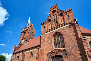 Fototapeta na wymiar historic, gothic red brick church with a belfry in the village of Bledzew