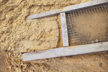 A sieve for sifting sand, all for building a house. View from above.