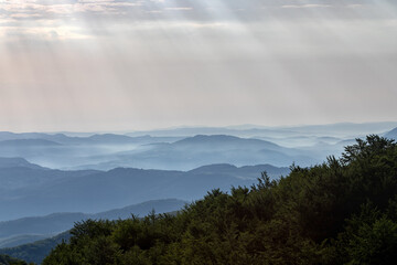 Landscape of mountain peaks. From the top you can see an expanse of mountain peaks that get lost on the horizon between the fog and the clouds. Abruzzo, Italy