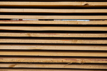 Building material in the form of fresh wooden planks at a road repair site. The repair process. Close-up.