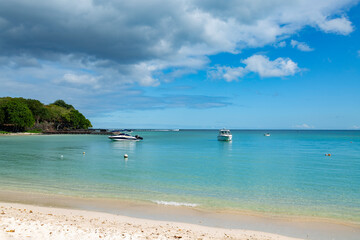 Fototapeta na wymiar tropical beach with boats on the island of Mauritius.