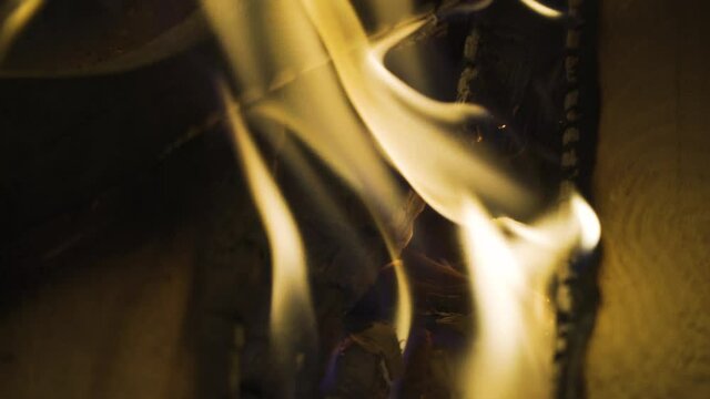 Embers glowing in bonfire at night, 4k