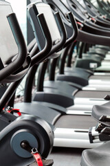 Fototapeta premium Detail image of Treadmill in fitness room background 