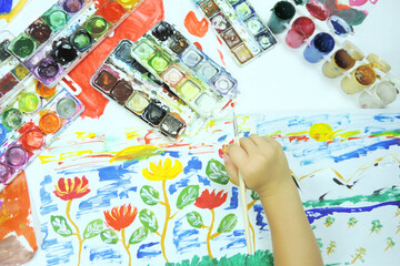 children's creativity paints and drawings hand with a brush for drawing