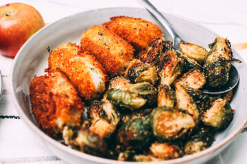 Fried potato croquettes and roasted brussel sprouts