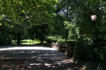 Fototapeta premium Empty Trail on a Shaded Bridge at Central Park during Summer in New York City
