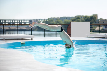 Man in the process of diving in swimming pool