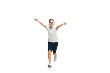 Happy kids, little and emotional caucasian boy jumping and running isolated on white background. Look happy, cheerful, sincere. Copyspace for ad. Childhood, education, happiness concept.